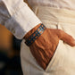 Bracelet homme Orwell Bleu Noyer porte au poignet avec une chemise en lin